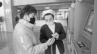 宁县第二人民医院新门诊楼内，医护人员帮助患者挂号。